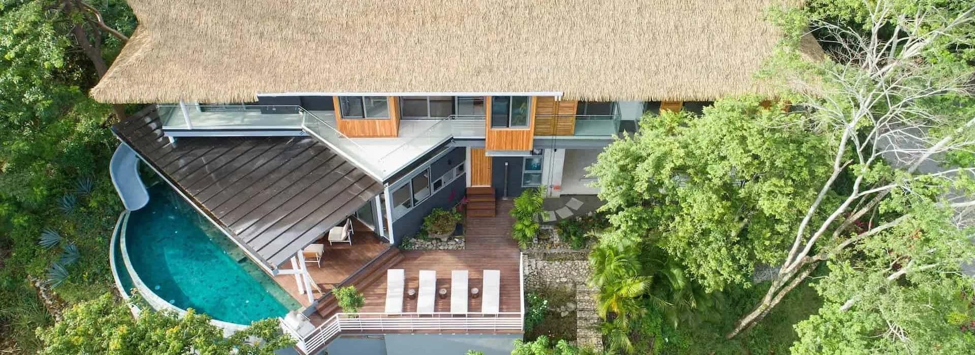 Villa property checkup Santa Teresa Costa Rica — tropical villa surrounded by green vegetation in warm afternoon light